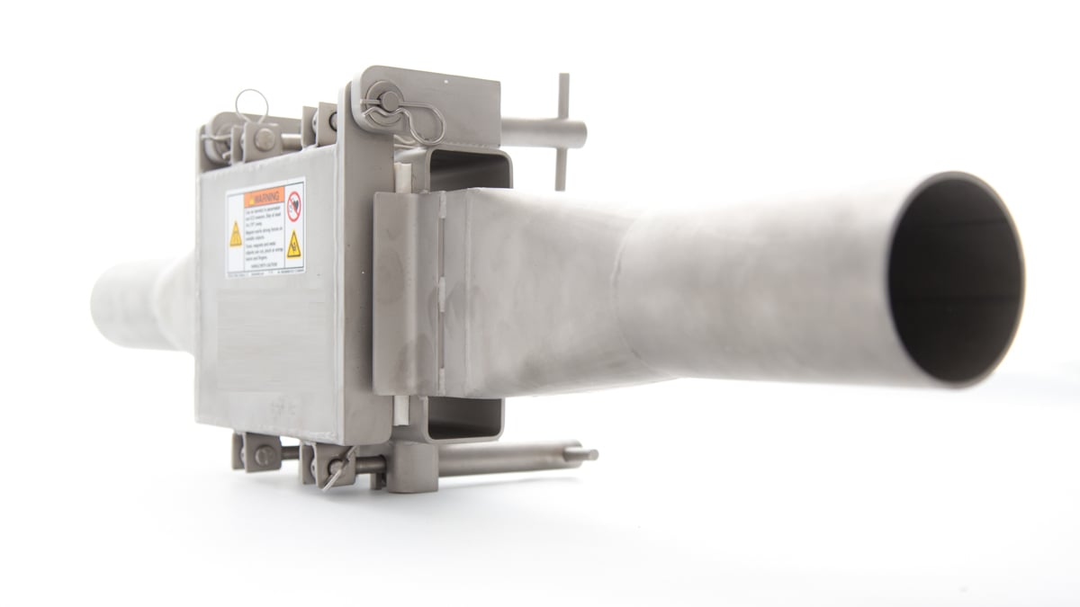 Bunting Pneumatic In-Line Magnet in a stainless steel housing mounted on a section of conveying pipe