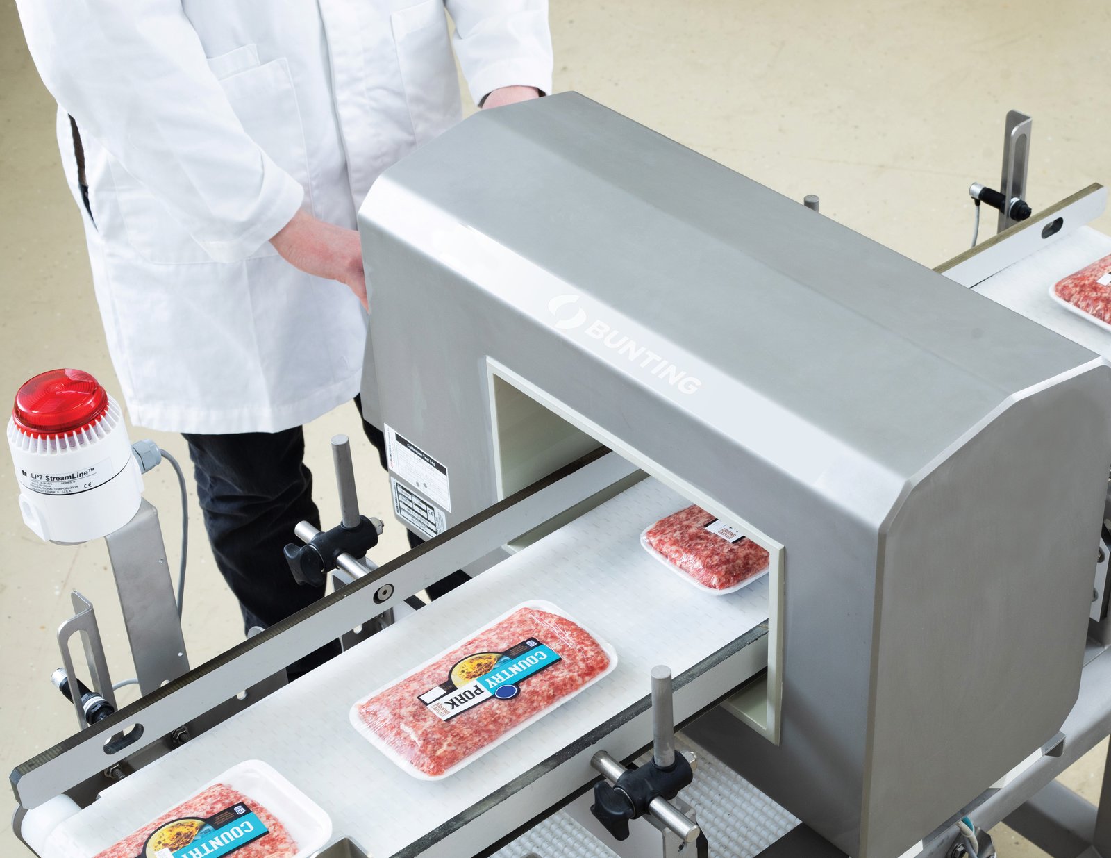 Bunting Performer DCM conveyor metal detector inspecting packaged pork