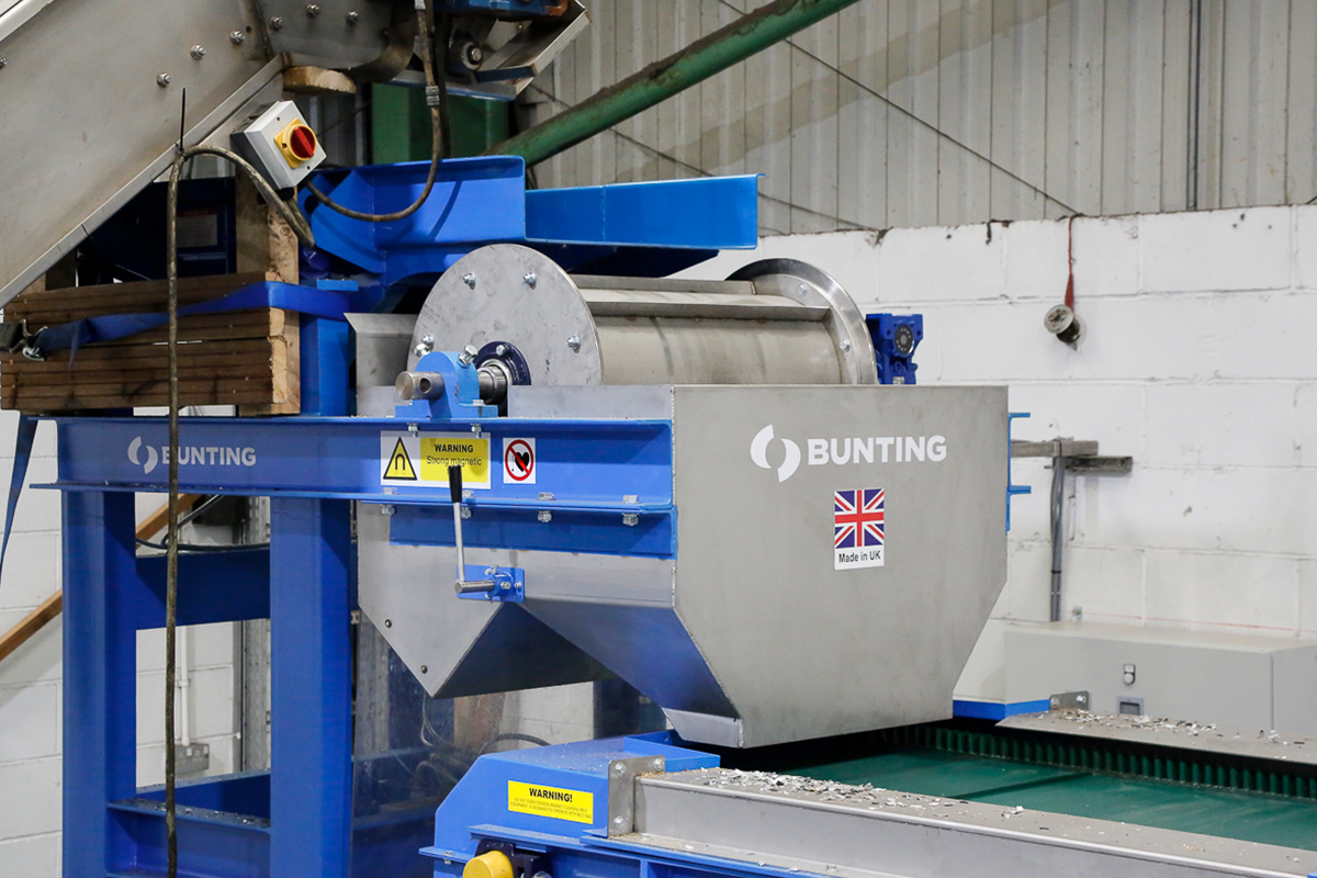 Bunting permanent drum assembly mounted above a conveyor