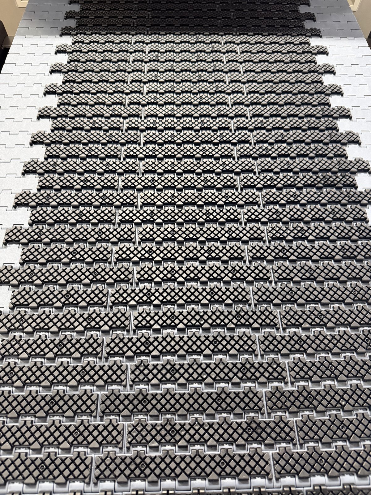 Close-up of the modular conveyor belt with square friction-top surfaces
