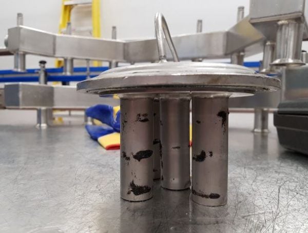 Fine ferrous contamination captured on tube magnets