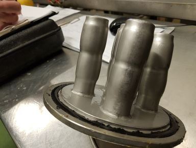 Damaged liquid magnetic filter showing tube distortion caused by weld failure