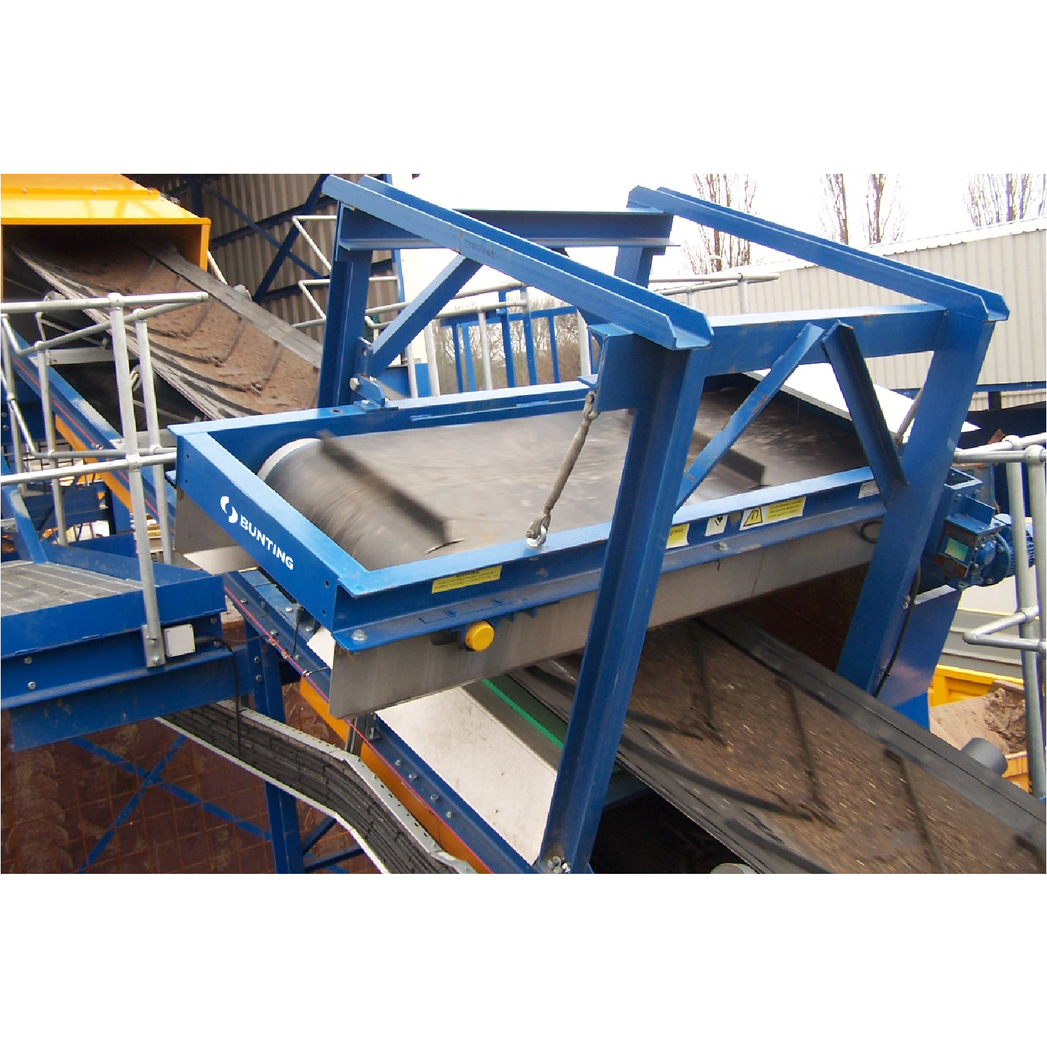 PCB overband magnet mounted above a conveyor.